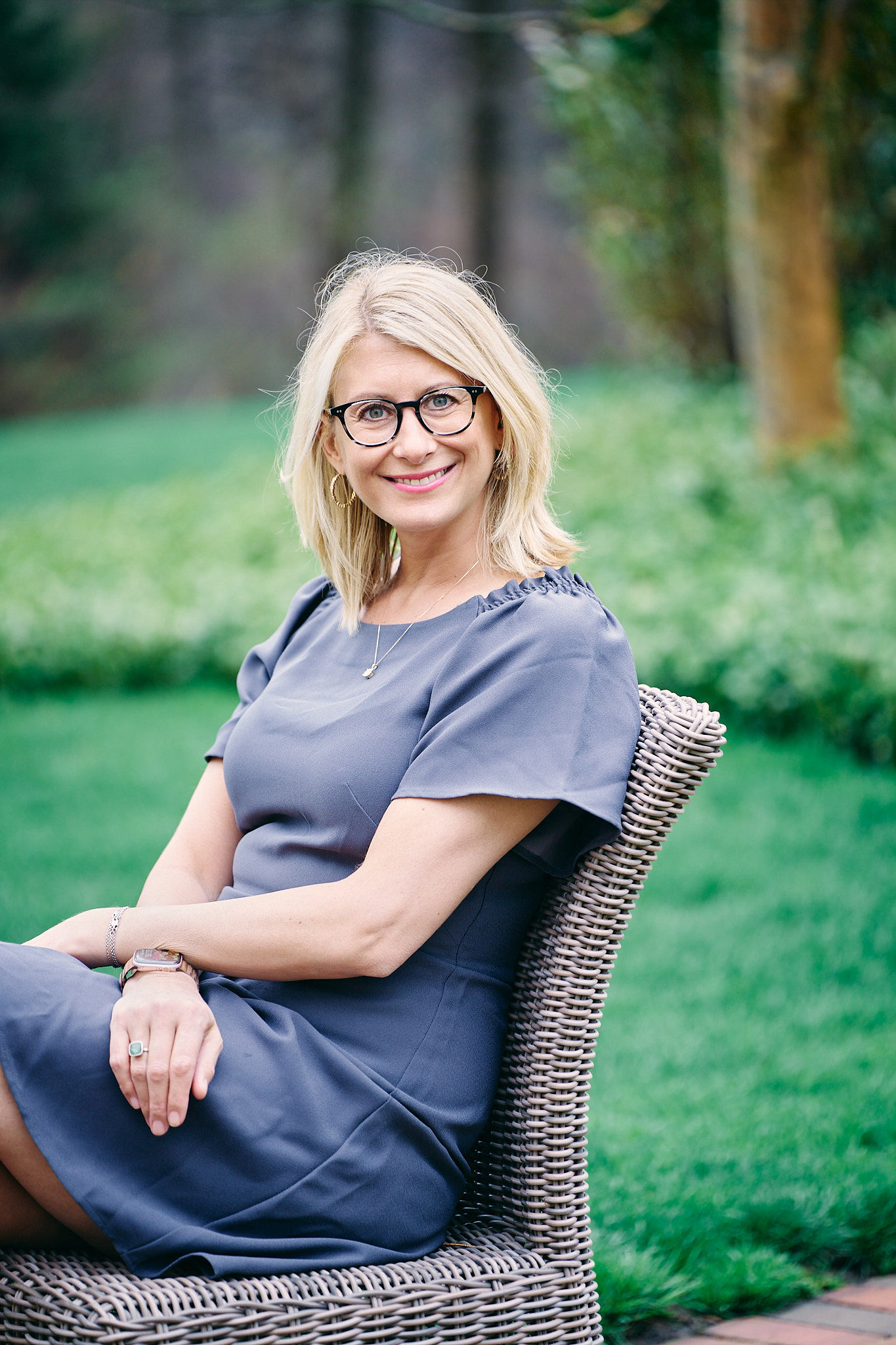 Ali Daggett seated outdoors in her garden